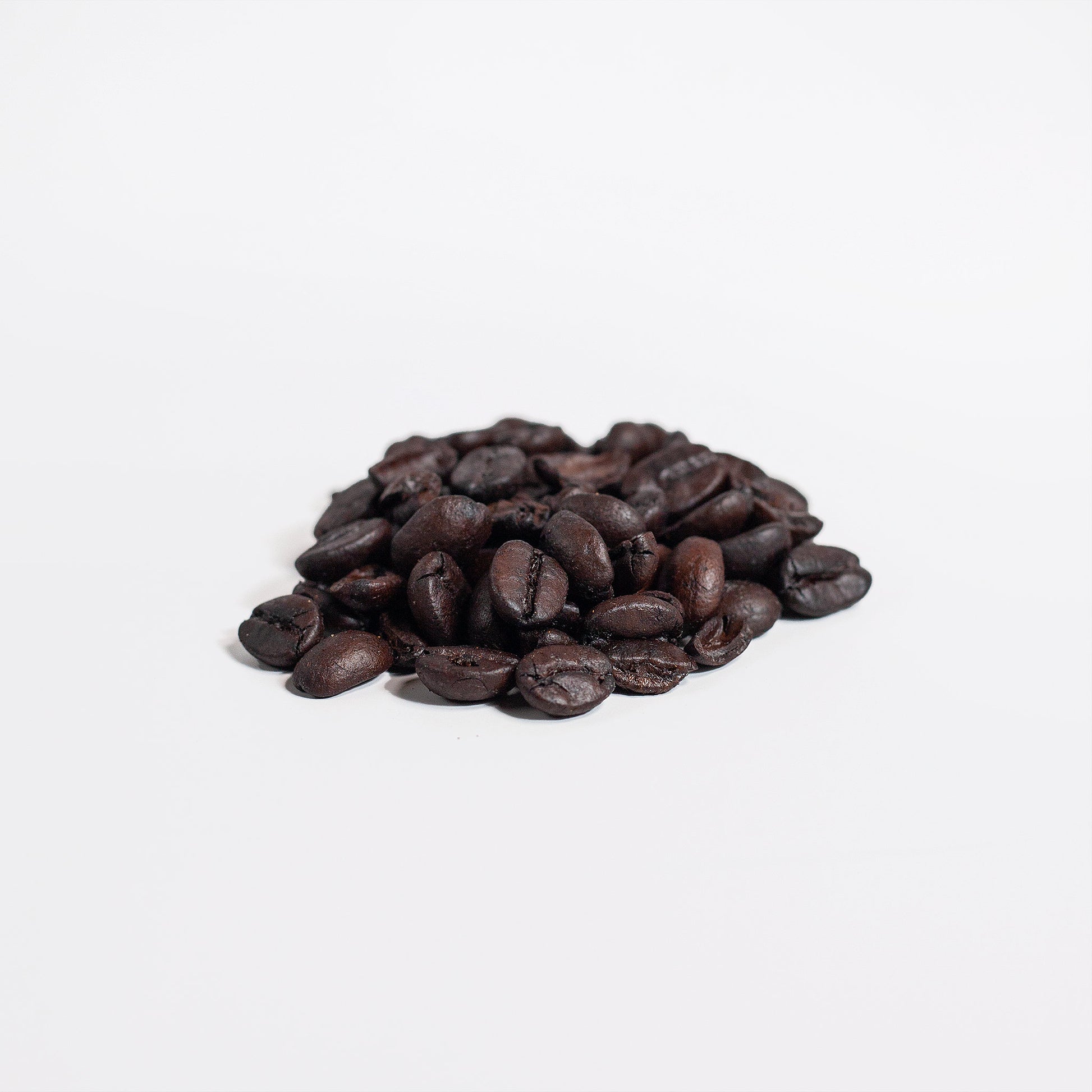 Pile of Manuka honey coffee beans on a white background