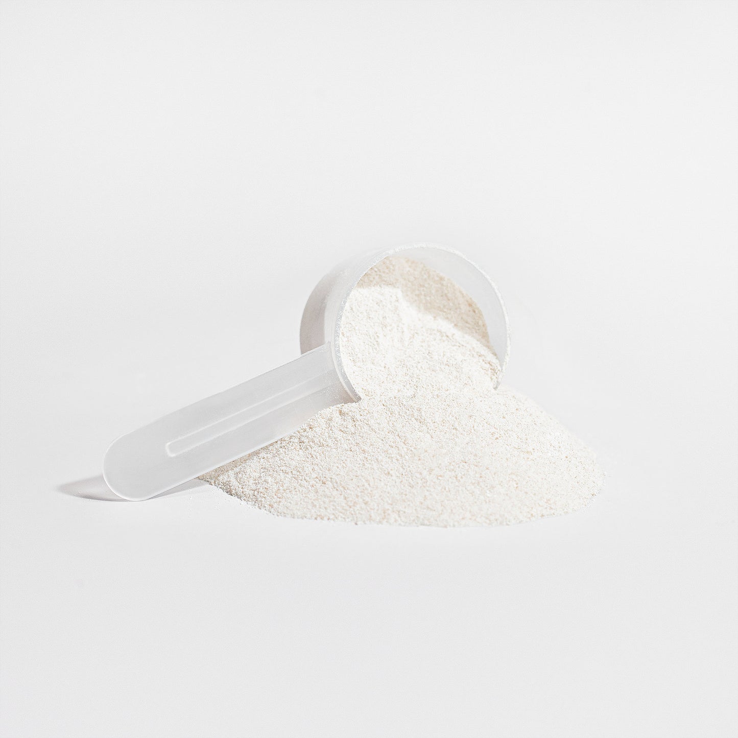 Virile Valour Grass-Fed Collagen Creamer Vanilla For Men Powder in a clear plastic scoop on a light gray background