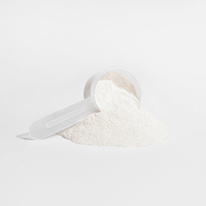 Virile Valour Grass-Fed Collagen Creamer Vanilla For Men Powder in a clear plastic scoop on a light gray background