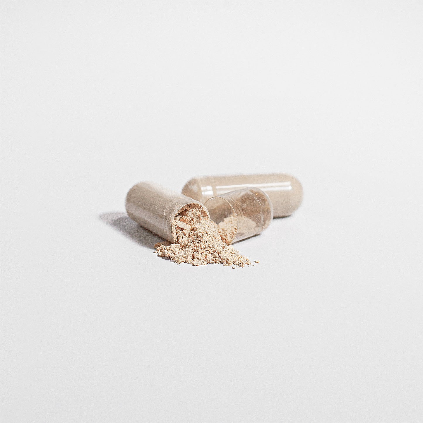 Virile Valour Lions Mane Mushroom For Men open capsules with a powdery LionsMane on a light gray background