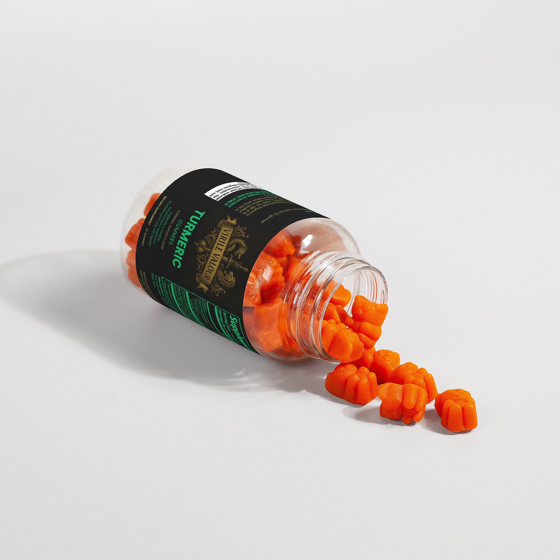 Orange Gummies spilling out of a black and green container on a white background